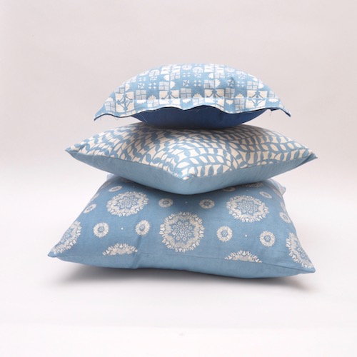 Stack of light indigo cushions. Light indigo cushions